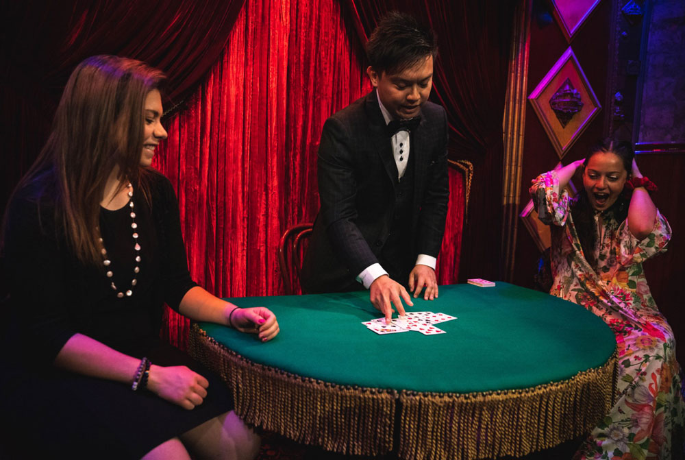 Table top magician showcasing incredible sleight of hand